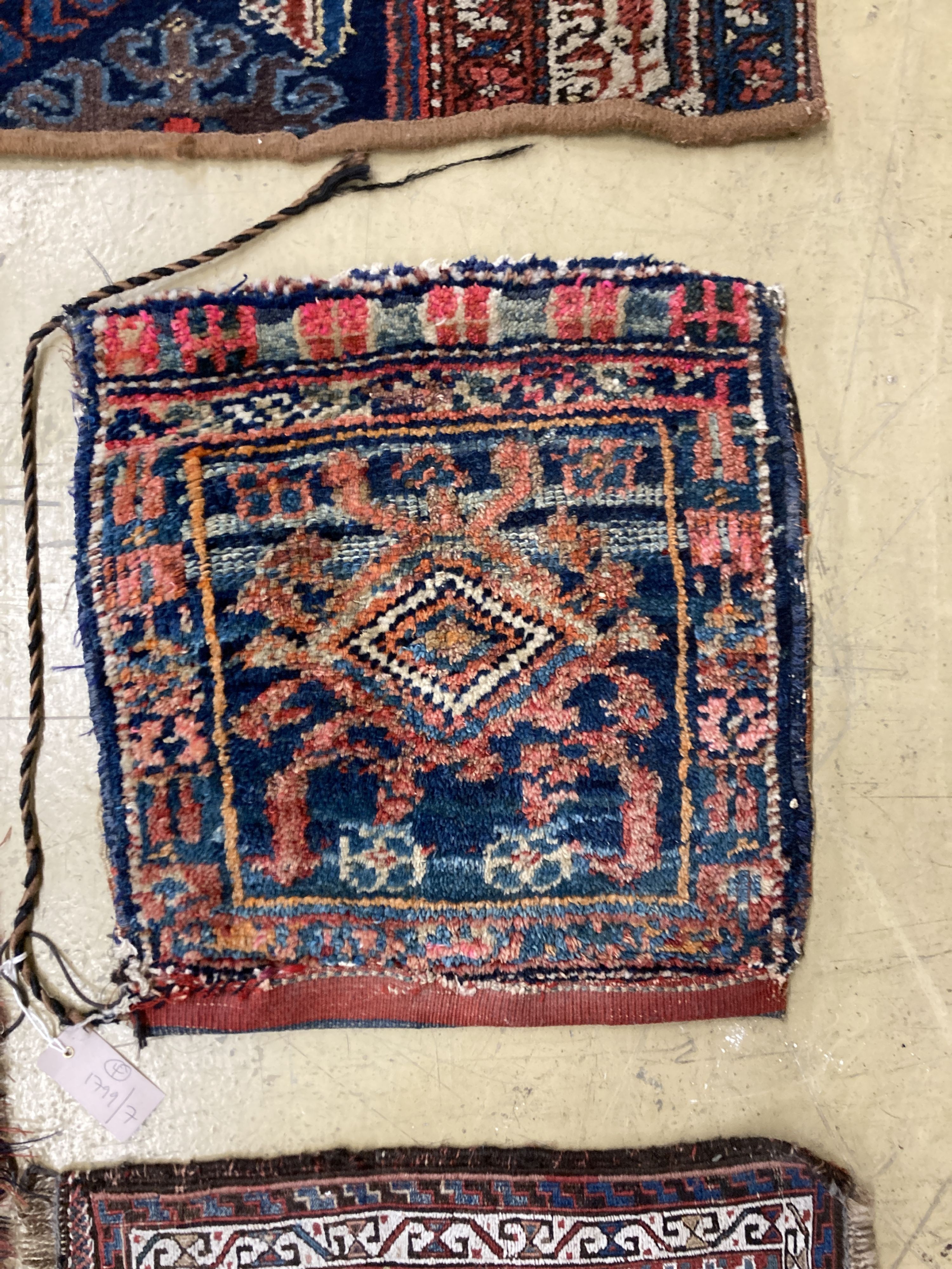 A Caucasian saddle bag and three mats, largest 100 x 40cm